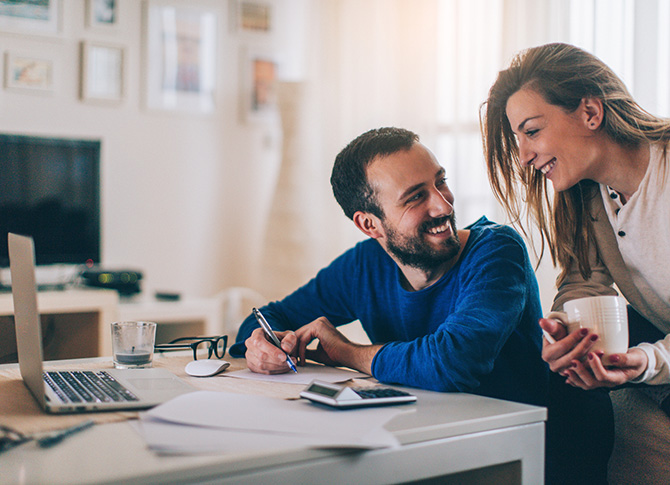 Couple going over finances in living room