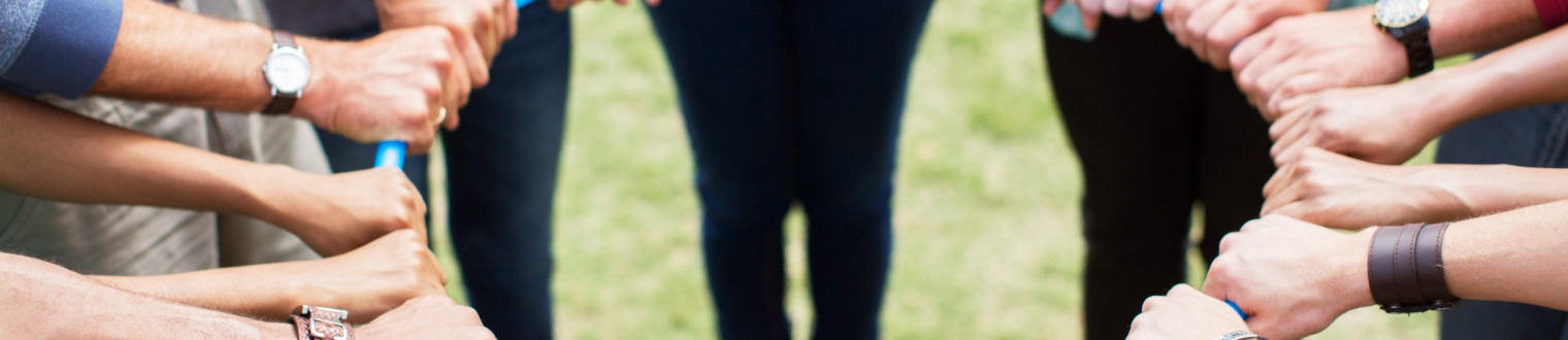 a group of hands on a plastic ring